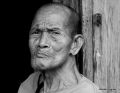 26 Old Man At A Wooden Wall in Black and White